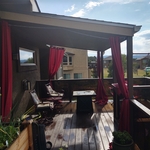 Roof canopy over a composite decking balcony.