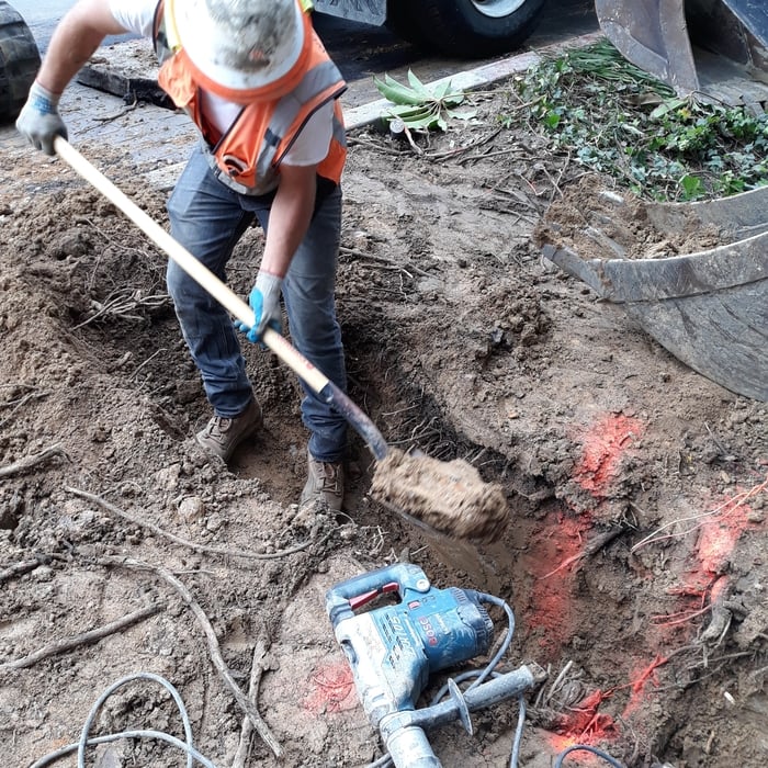 Hand digging under existing utilities