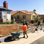 Installation in progress for a new decorative hardscape wall and lawn