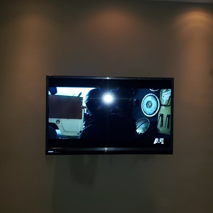 55 inch mounted on a full motion bracket. Setup for use with cable.
