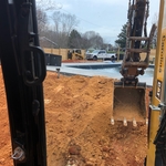 Filling to pool and shaping the ground.