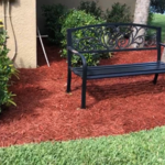 Applied red mulch throughout the front and backyard.