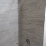Install new shower valve with trim, new tub with removing old cast iron p-trap.