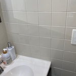 Cleaned tile area next to sink in bathroom