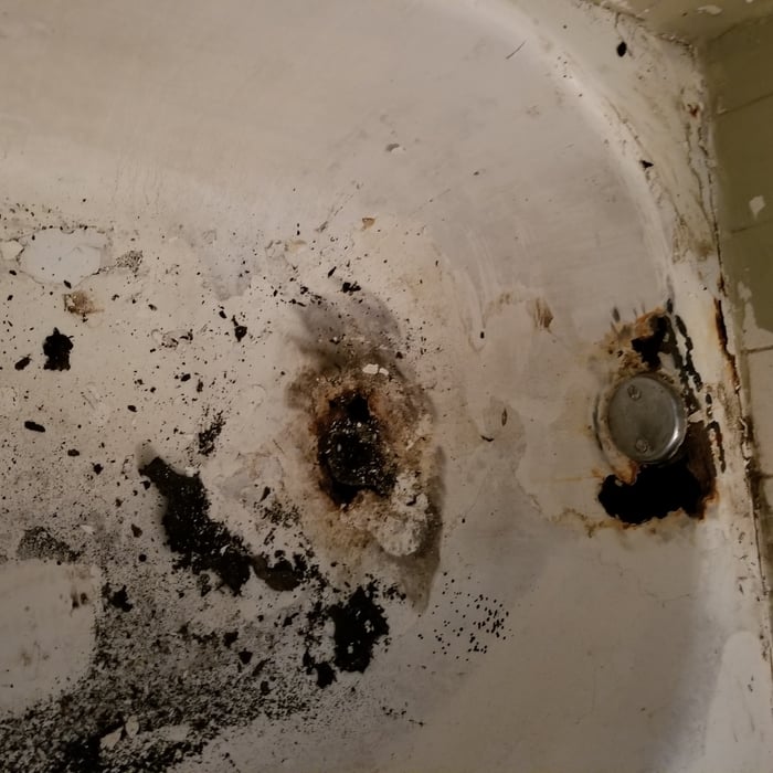 Major holes around the overflow and drain.