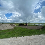 Topsoil stripped out, and first layer of screenings spread