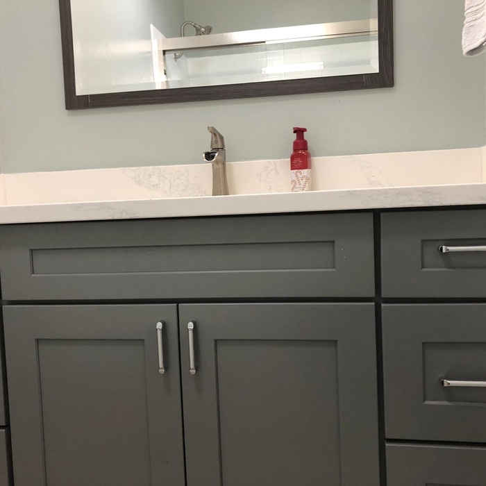 Cabinets, faucet, and mirror