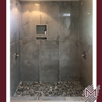 Gray Porcelain Wall Tile, Contemporary Walk-in Shower, Niche, and Decorative Pebble Flooring Tile Installation