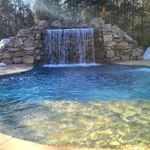 20x45 Gunite pool with a stone beach iterance, water deck jets and a beautiful stone waterfall.