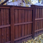 Walnut color stain makes this beautiful fence stick out in the neighborhood.