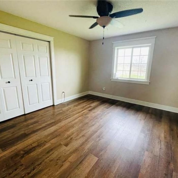 This formally pink kids bedroom got revamped with new flooring, custom trim, ceiling fan, and paint.