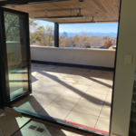 View from inside house exiting onto rooftop deck.