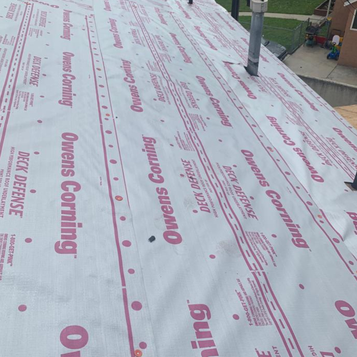 Rubber capped nails, hand-fastened through synthetic underlayment. Bye, bye tar paper!