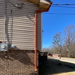 Old gutter on the corner of the house, downspout too high
