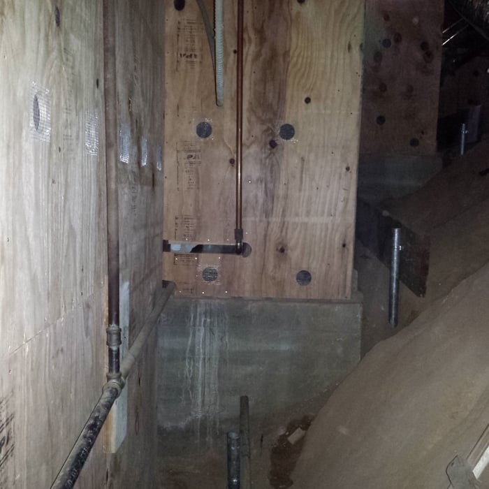 Plywood sheathing on tall cripple walls with ventilation holes.