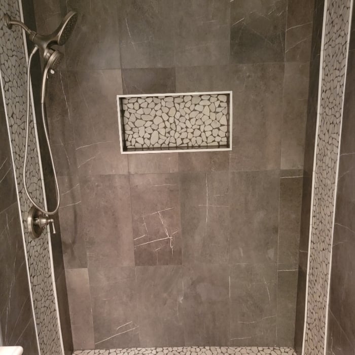 After Photo: Tile Walk in (Before door install) with two waterfall accents and recessed shelf