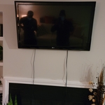 Tv mount above a fireplace