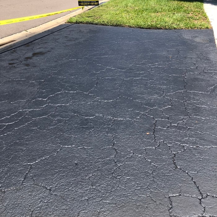 Driveway sealcoating