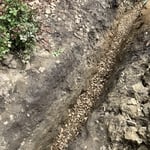 part of the drain pipe we installed, gravel underneath and on top
