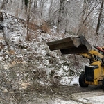 using the tractor to clear downed trees in the snow storm