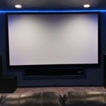 110 inch projector screen, LED accent lighting with flush mount Can lights on dimmer switches. Recessed equipment box just below the screen.