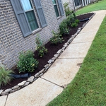 Cleaned out flowerbeds & added Arkansas fieldstone for landscape edging & planted new plants & Shurbs & applied fresh mulch to flowerbeds