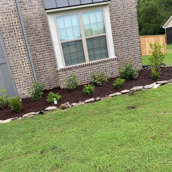 Before & after pictures/ Cleaned out flowerbeds & added Arkansas fieldstone for landscape edging & planted new plants & Shurbs & applied fresh mulch to flowerbeds