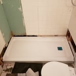 Install shower pan and drain