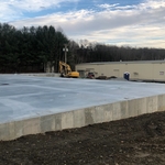 Building foundation and floor with underground conduit in concrete floor