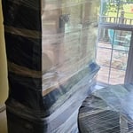 China cabinet wrapped and protected with pads, cardboard, and shrink wrap.