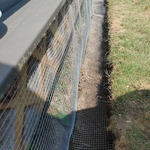 Hardware cloth is cut to fit and fastened with metal screws and washers