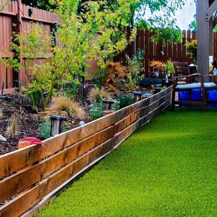 Vibrant garden bed with a lattice retaining fence. Simple, modern, and very low maintenance.