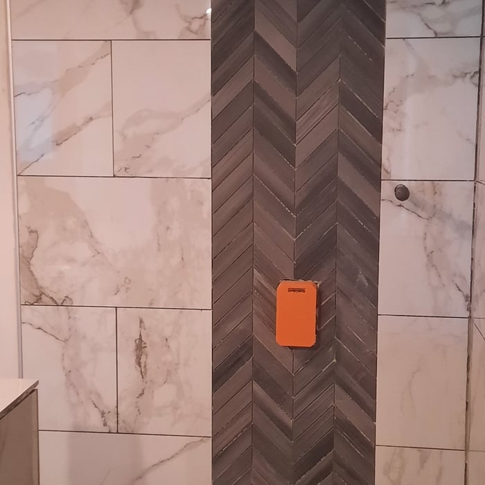Center wall pattern tile coming up from shower floor