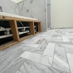 Standing shower, bathroom floor and tub surround.