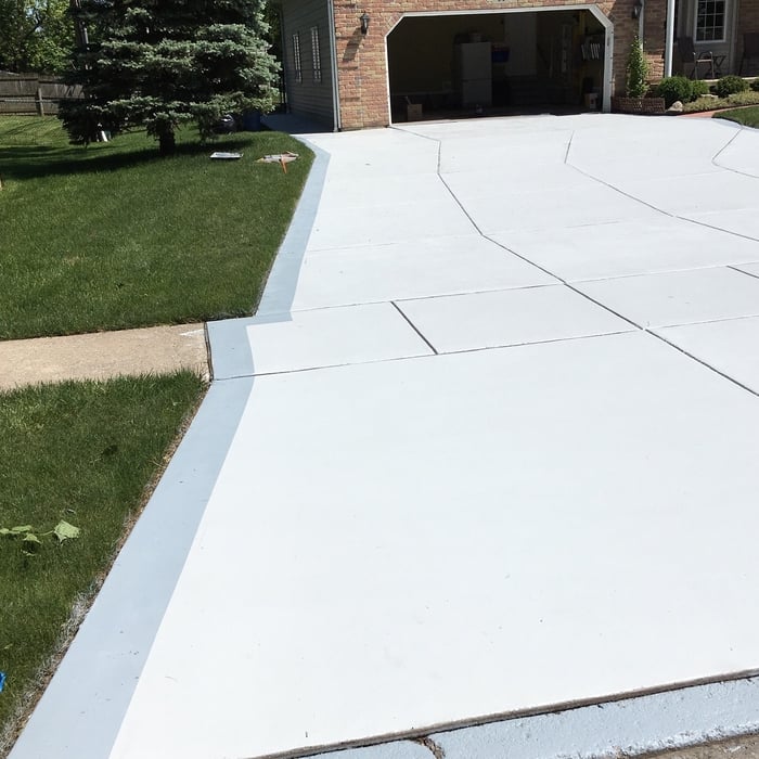 Driveway repaired and color Sealed with added border