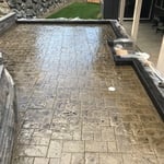 Stamped Concrete Patio with Block Retaining Wall