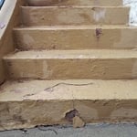 A view of the extensive damage on the steps and the amount of material that had to be removed in order to make repairs. The removal was extensive, up to 1" of material was removed.