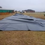 Unfolding the liner to pull into the pond for intsall