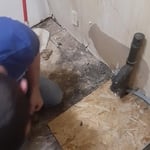 Tore up the bad part or floor and install new subfloor and linoleum