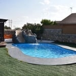 After: Artificial grass installed, pool repaired, painted and filled