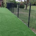 Added steel edging along bottom of wrought iron fence to prevent grass and weed intrusion into the turf area.