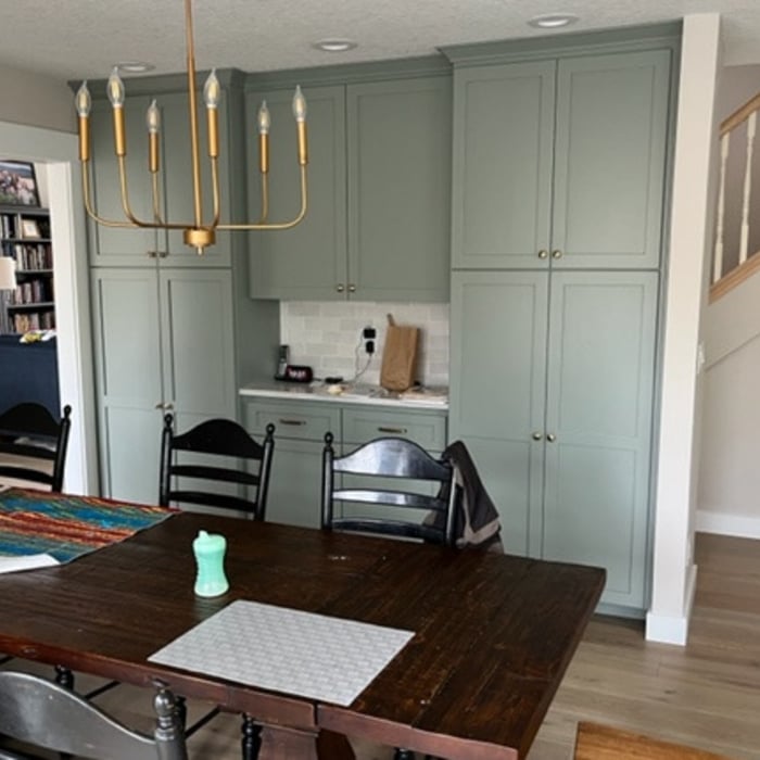 New dining area with pantry cabinets & coffee bar in previous kitchen space