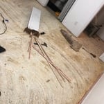 Image taken after direct glue down carpet was removed and disposed of. Revealing a cold, padless concrete bedroom floor.