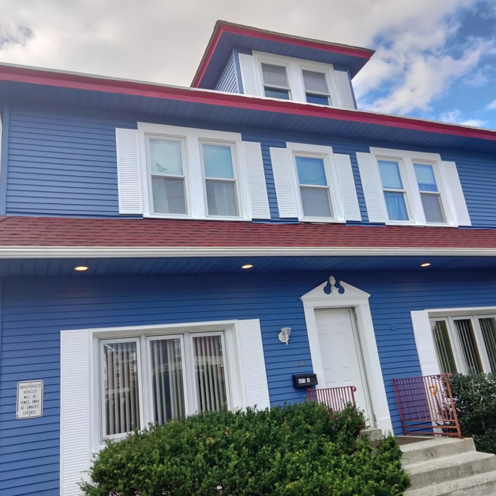 Front of building after soffit repair pressure wash and paint.