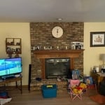Cabinets with shelves flanking fireplace