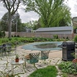 The client's rockwall surrounding her pool was overgrown, full of buckthorn and grass.