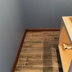 Tile floor and walnut baseboards