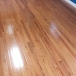 Hardwood nailed down and baseboards installed.