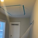 Outlining the position of the skylight on the ceiling for the cut.