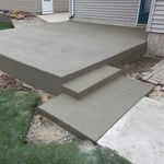 Elevated patio with step and sidewalk square